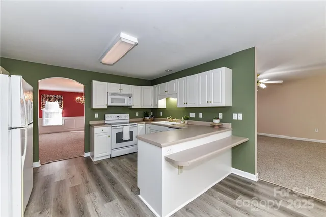 a kitchen with cabinets appliances a sink and a counter top