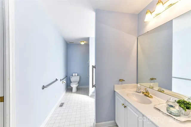 a bathroom with a sink a mirror and a shower