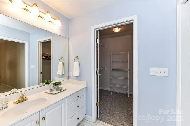 a bathroom with a granite countertop shower and a sink
