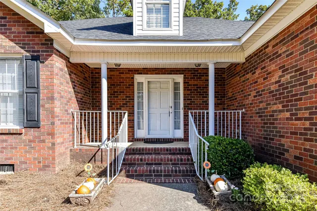 a view of a brick house with a large windows