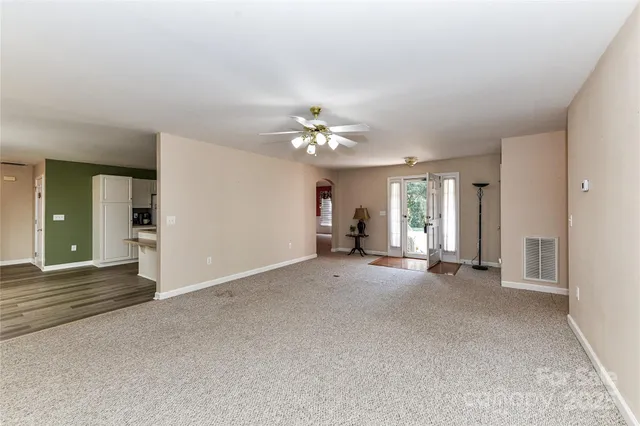 a view of a livingroom with a fireplace and chandelier fan