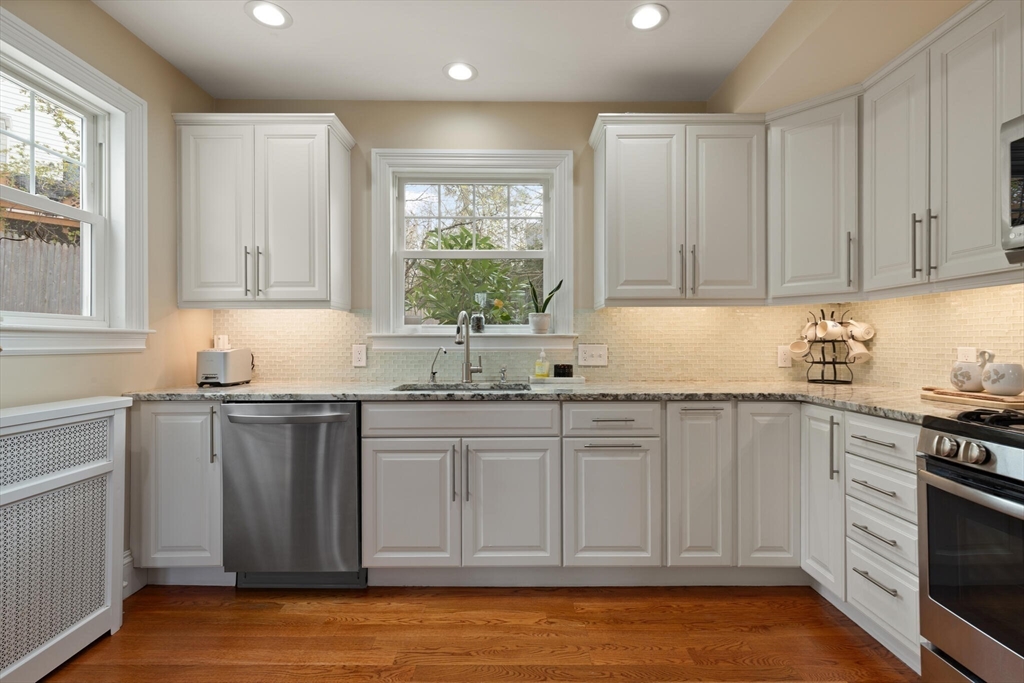 29 Station Street Sharon, MA 02067 - Photo 19 of 42 a kitchen with granite countertop white cabinets and stainless steel appliances