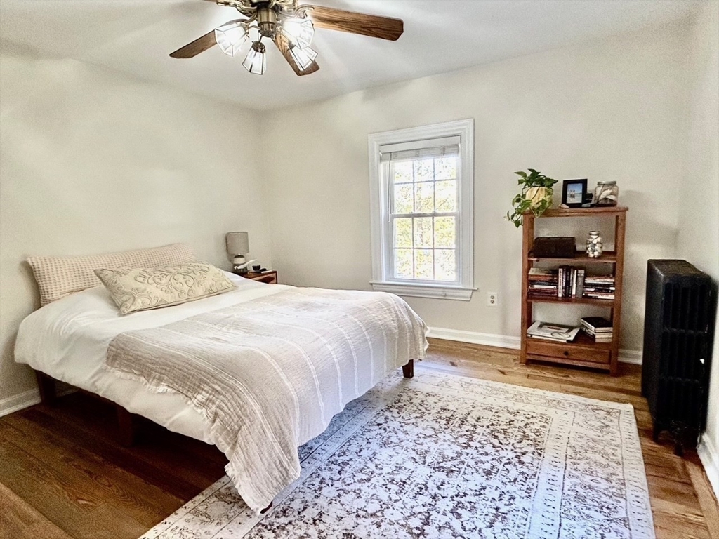 29 Station Street Sharon, MA 02067 - Photo 27 of 42 a bedroom with a bed a dresser and book shelf