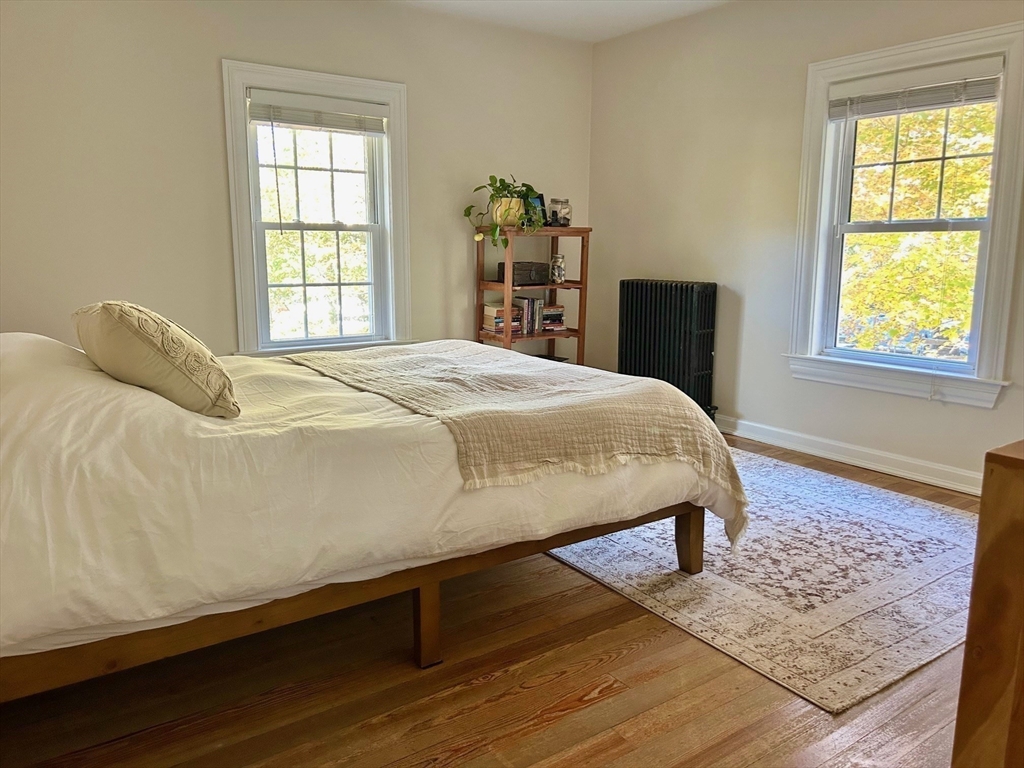 29 Station Street Sharon, MA 02067 - Photo 28 of 42 a bedroom with a bed and wooden floor