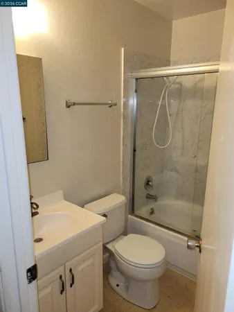 a bathroom with a shower toilet and sink