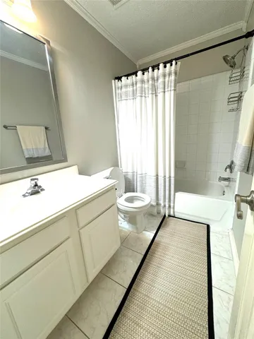 a bathroom with a sink a toilet a mirror and shower