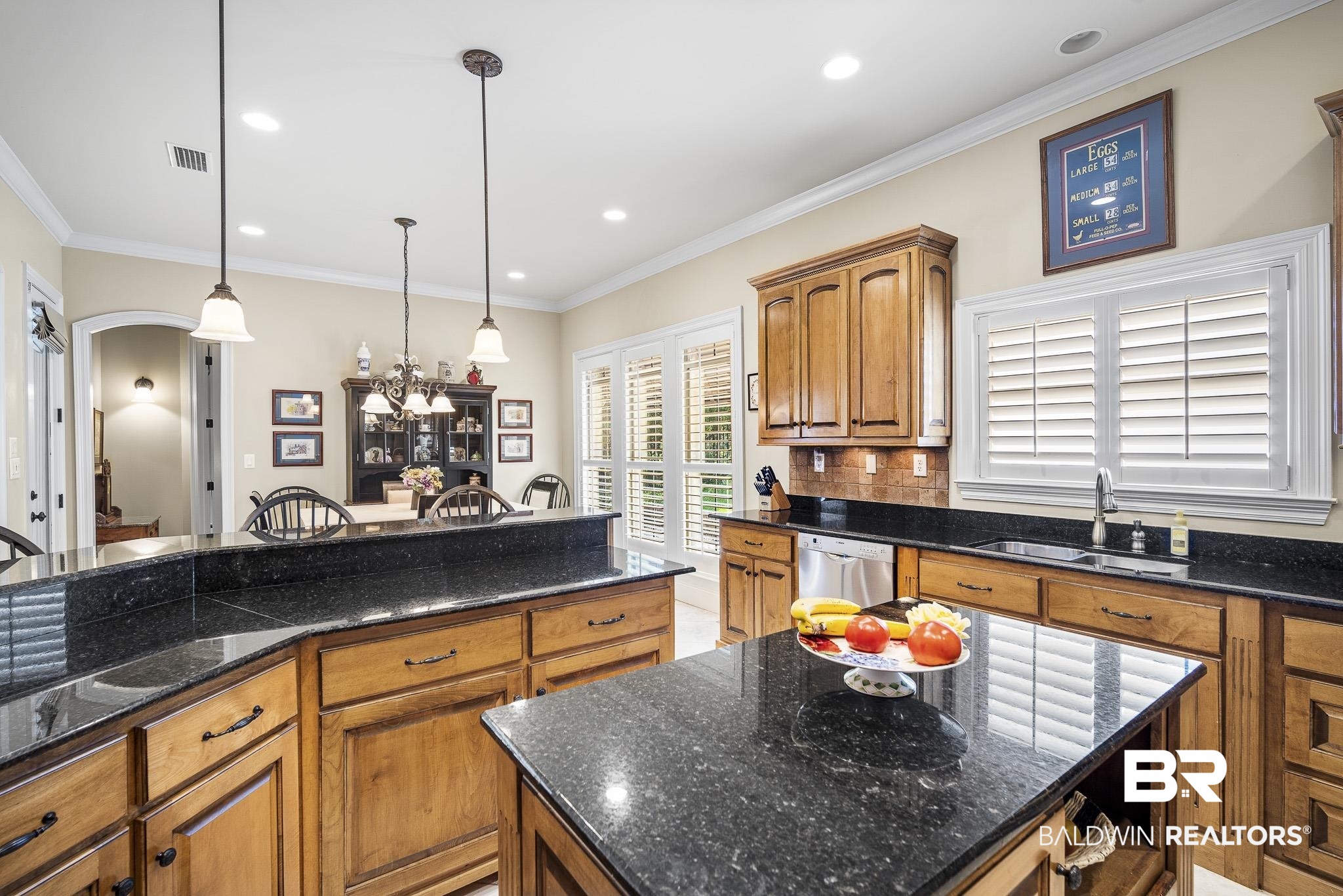 7090 Carson Lane Daphne, AL 36527 - Photo 11 of 37 Kitchen featuring decorative light fixtures, decorative backsplash, stainless steel dishwasher, crown molding, and a center island