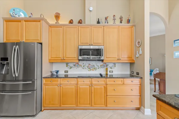 a kitchen with stainless steel appliances a refrigerator sink and cabinets