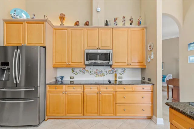 a kitchen with stainless steel appliances a refrigerator sink and cabinets