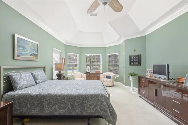 a bedroom with a large bed and a window