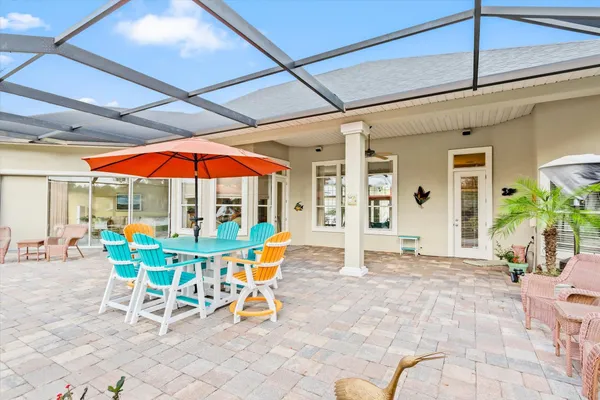 a patio with a table and chairs under an umbrella