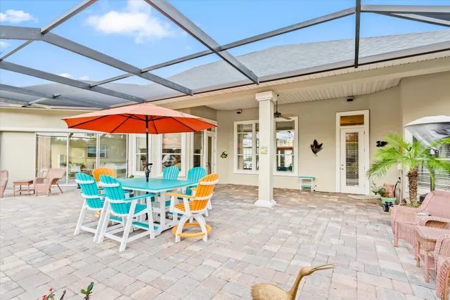 a patio with a table and chairs under an umbrella