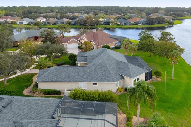 an aerial view of a house with a lake view
