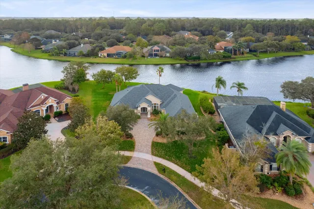 an aerial view of a house with a lake view