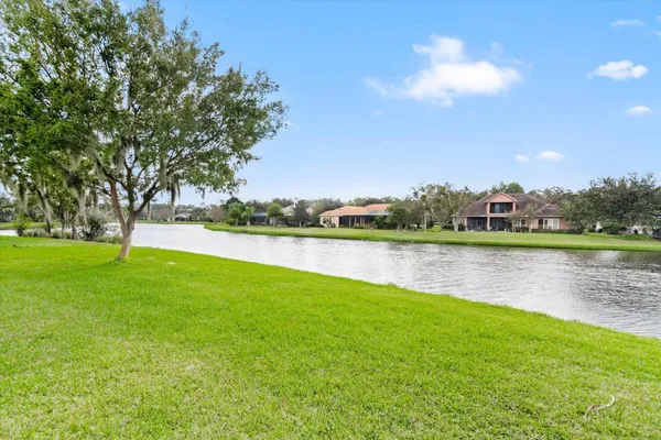 a view of a lake with houses in the background