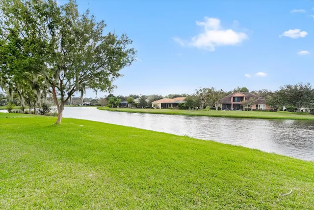 a view of a lake with houses in the background
