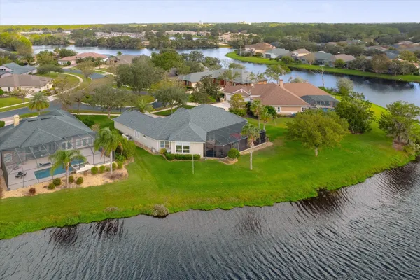 an aerial view of residential houses with outdoor space and river