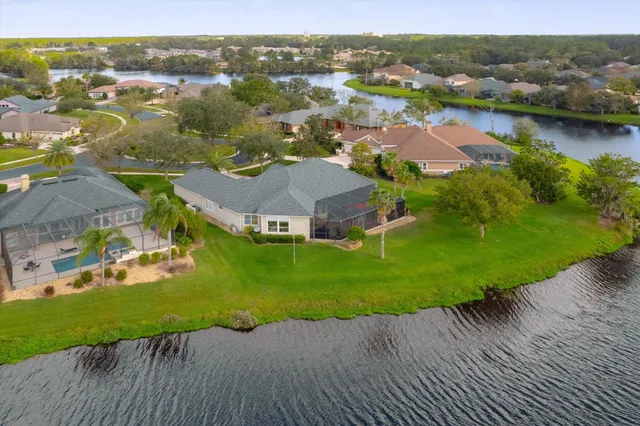 an aerial view of residential houses with outdoor space and river