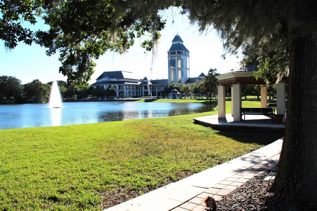 a view of a house with yard and lake view