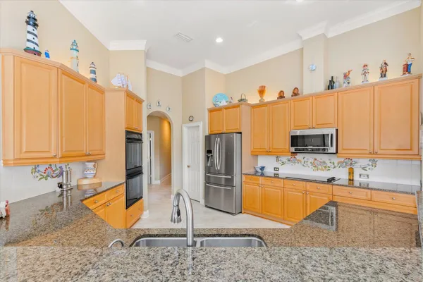 a kitchen with stainless steel appliances granite countertop a refrigerator and a sink