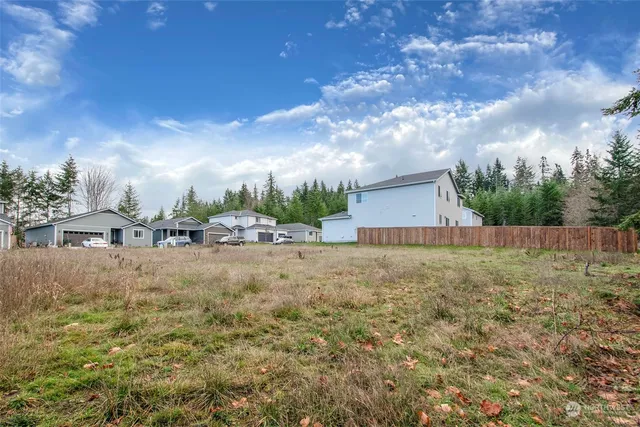 a backyard of a house with lots of green space and fog