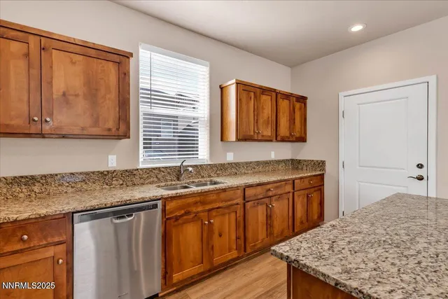 a kitchen with stainless steel appliances granite countertop a refrigerator and a sink