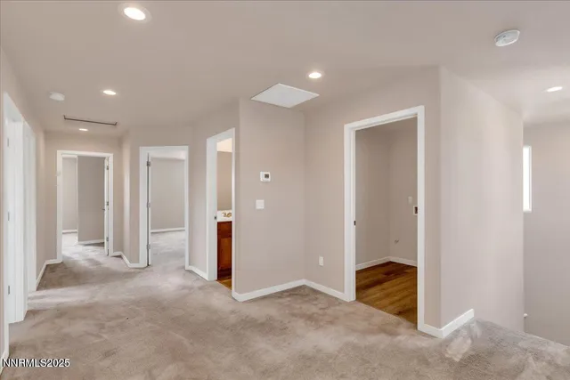 a view of a hallway with wooden shelves
