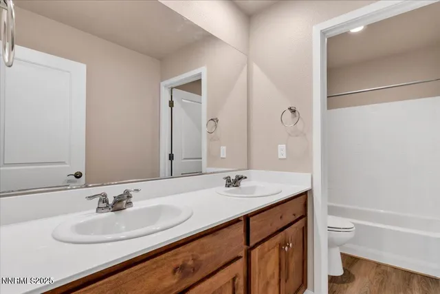 a white toilet sitting next to a bathtub