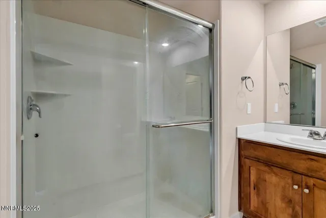 a bathroom with a granite countertop sink a toilet and a mirror