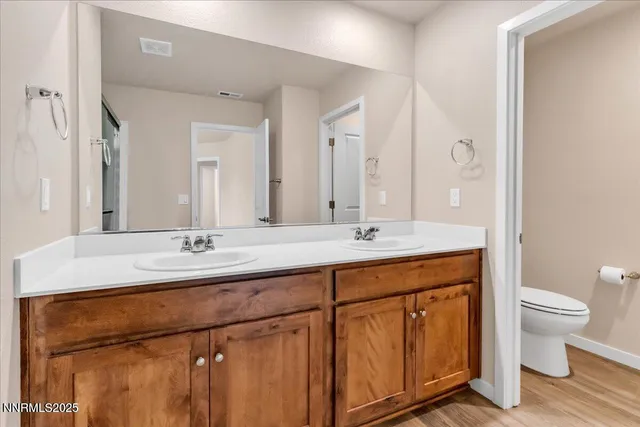 a bathroom with a sink shower and a mirror