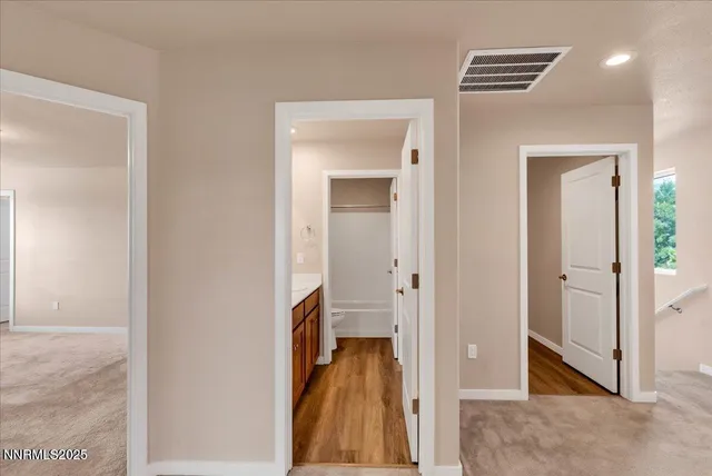 a view of a hallway with wooden shelves