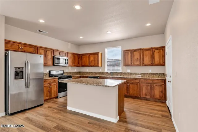 a kitchen with a sink stove top oven and refrigerator
