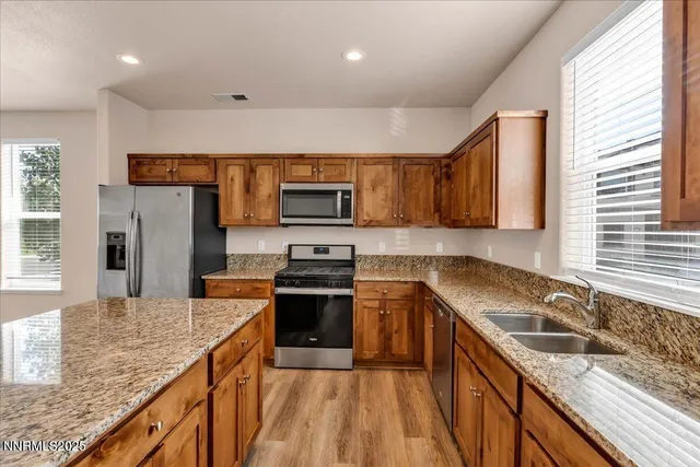 a view of a kitchen with a sink and a refrigerator