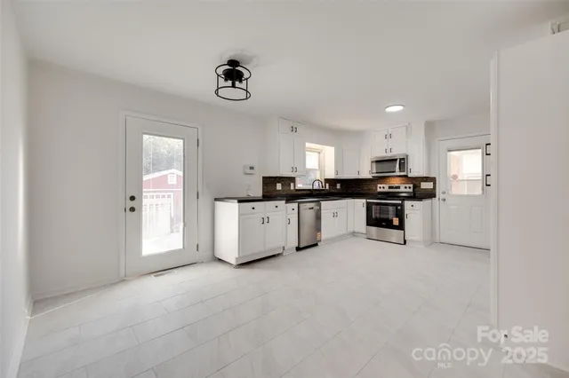 a large kitchen with cabinets and stainless steel appliances