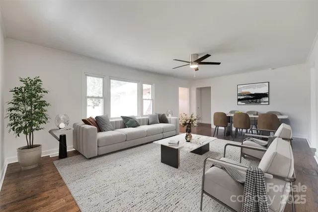 a living room with furniture a chandelier and a window
