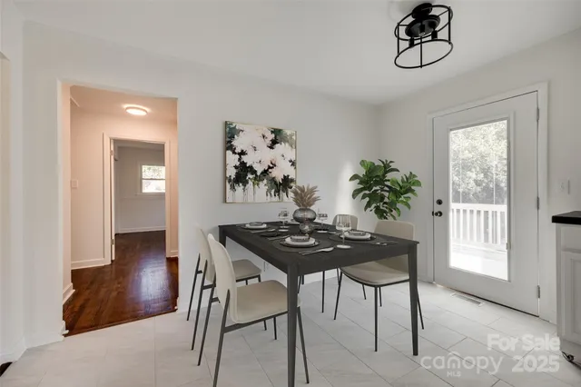 a view of a dining room with furniture and chandelier