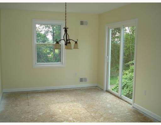 504 Commerce Street Pittsburgh, PA 15215 - Photo 5 of 11 Dining Room. The dining room has wonderful natural light with a window and sliding glass door and the chandalier is very tasteful.