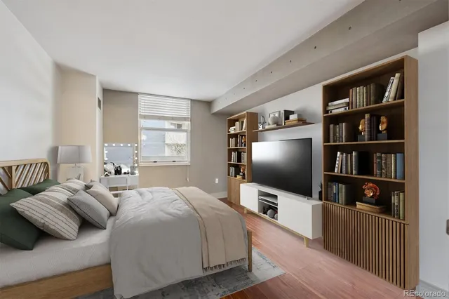 a bedroom with furniture and a flat screen tv