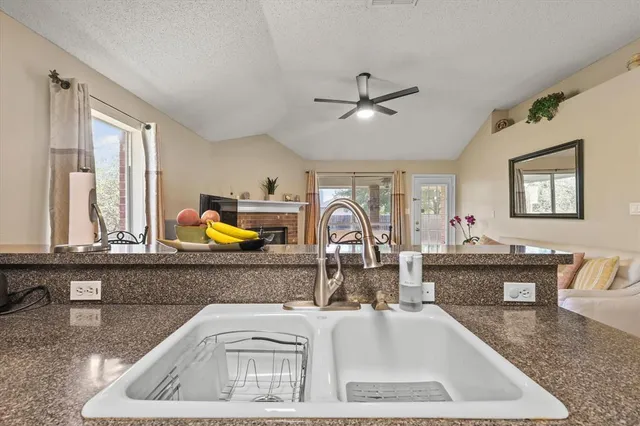 a view of living room with granite countertop furniture and fireplace