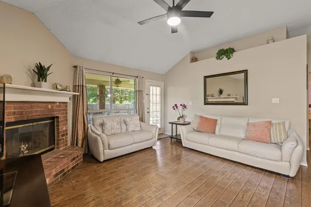 a living room with furniture and a fireplace