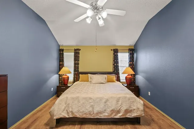 a bed sitting in a bedroom next to a window