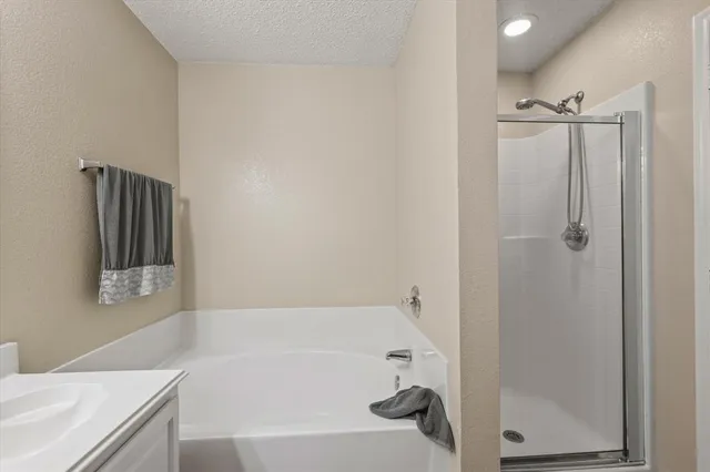 a bathroom with a bathtub and a shower