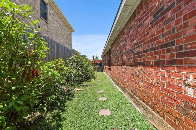 front view of a brick house with a yard