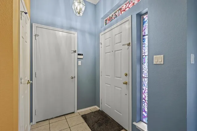 a view of a hallway with entryway door
