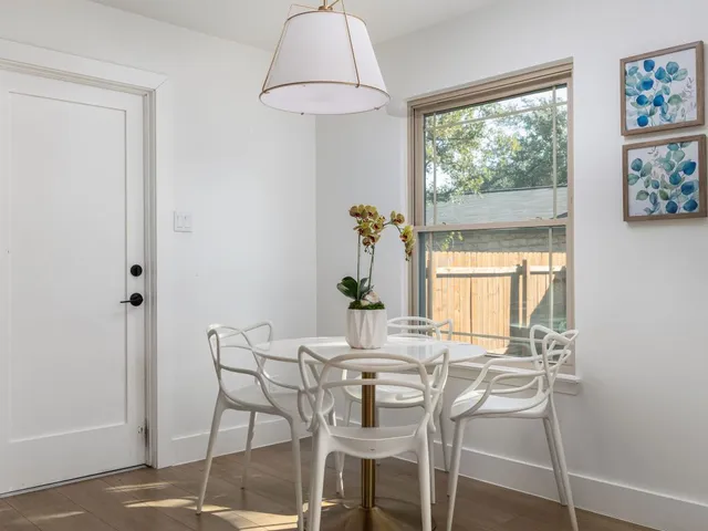 a dining room with furniture and window