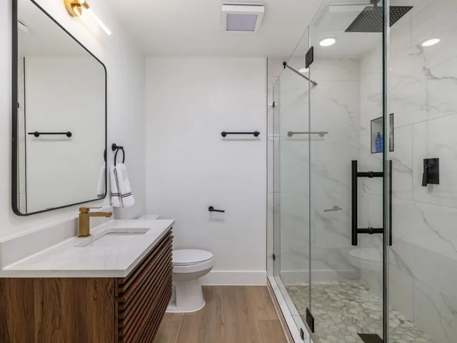 a bathroom with a sink toilet and shower