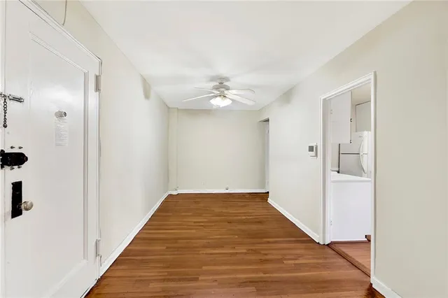 a view of a hallway with wooden floor