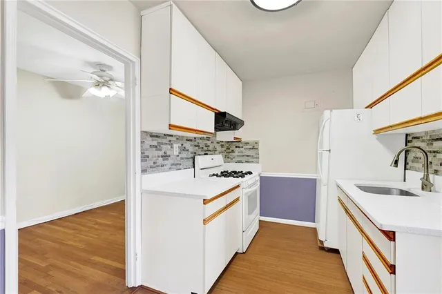 a kitchen with a sink and a refrigerator