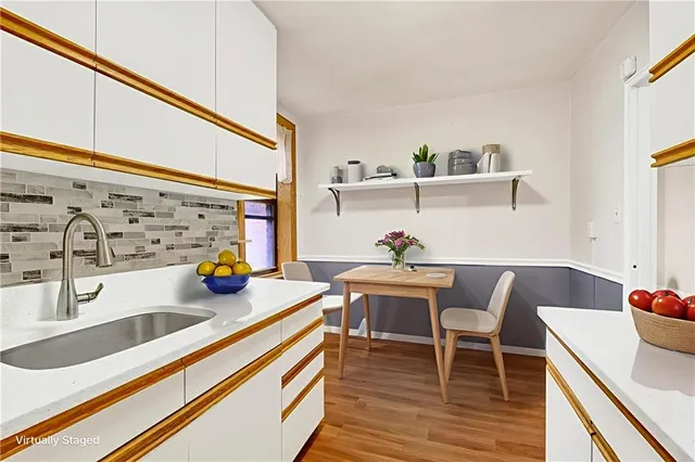 a kitchen with sink and cabinets