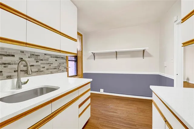 a view of kitchen cabinets and wooden floor